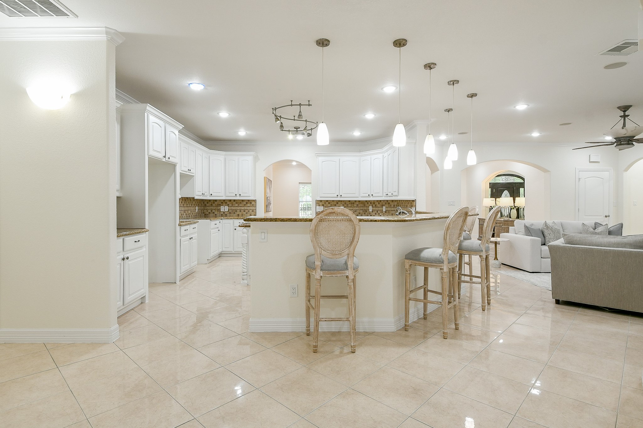 404 Moss Street Houston, TX 77009 - Photo 15 of 40 a large kitchen with white cabinets and stainless steel appliances
