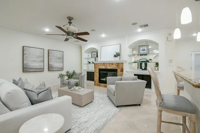 a living room with furniture a fireplace and a chandelier