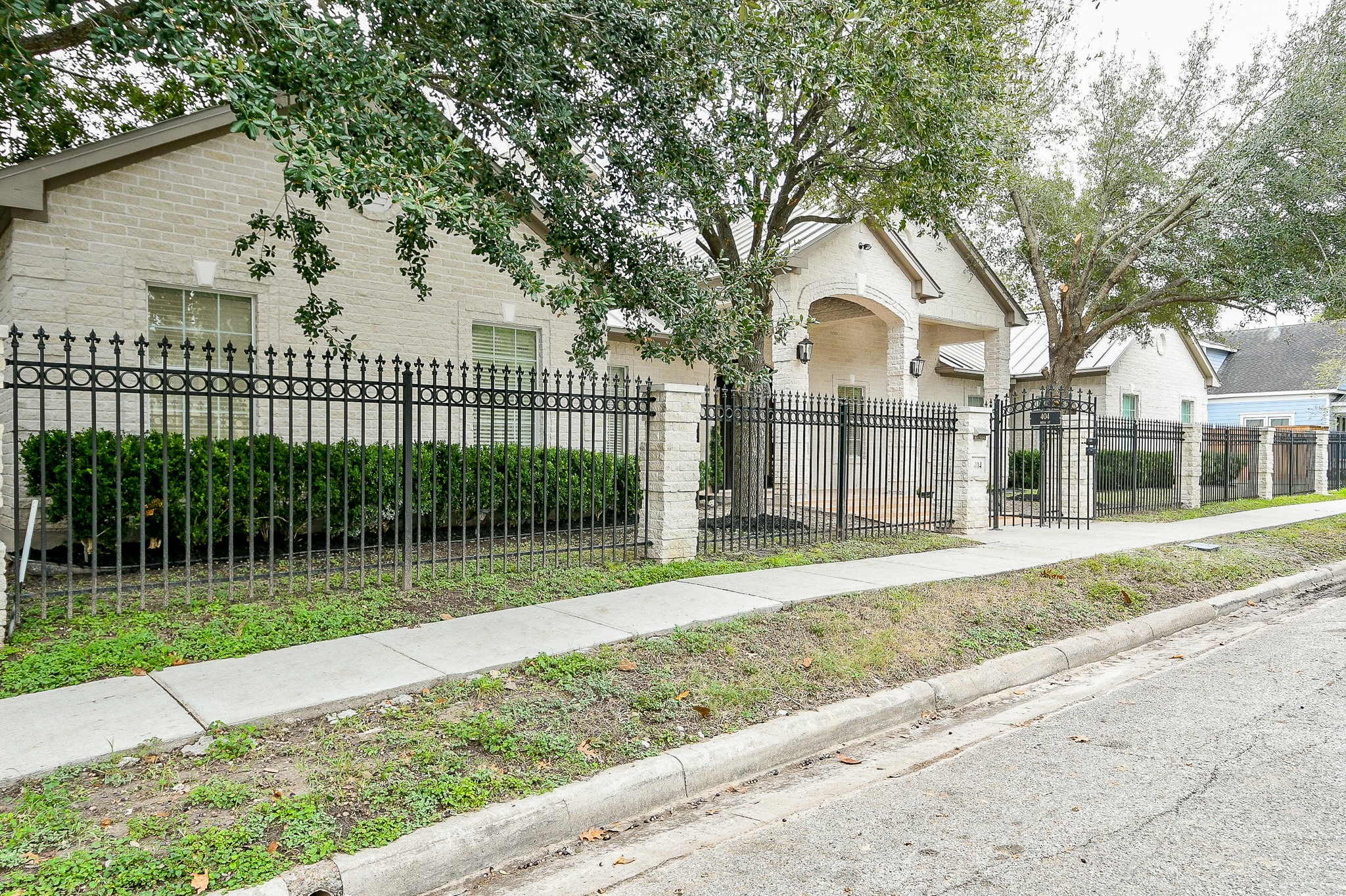 404 Moss Street Houston, TX 77009 - Photo 2 of 40 a view of a white house with a yard and large tree