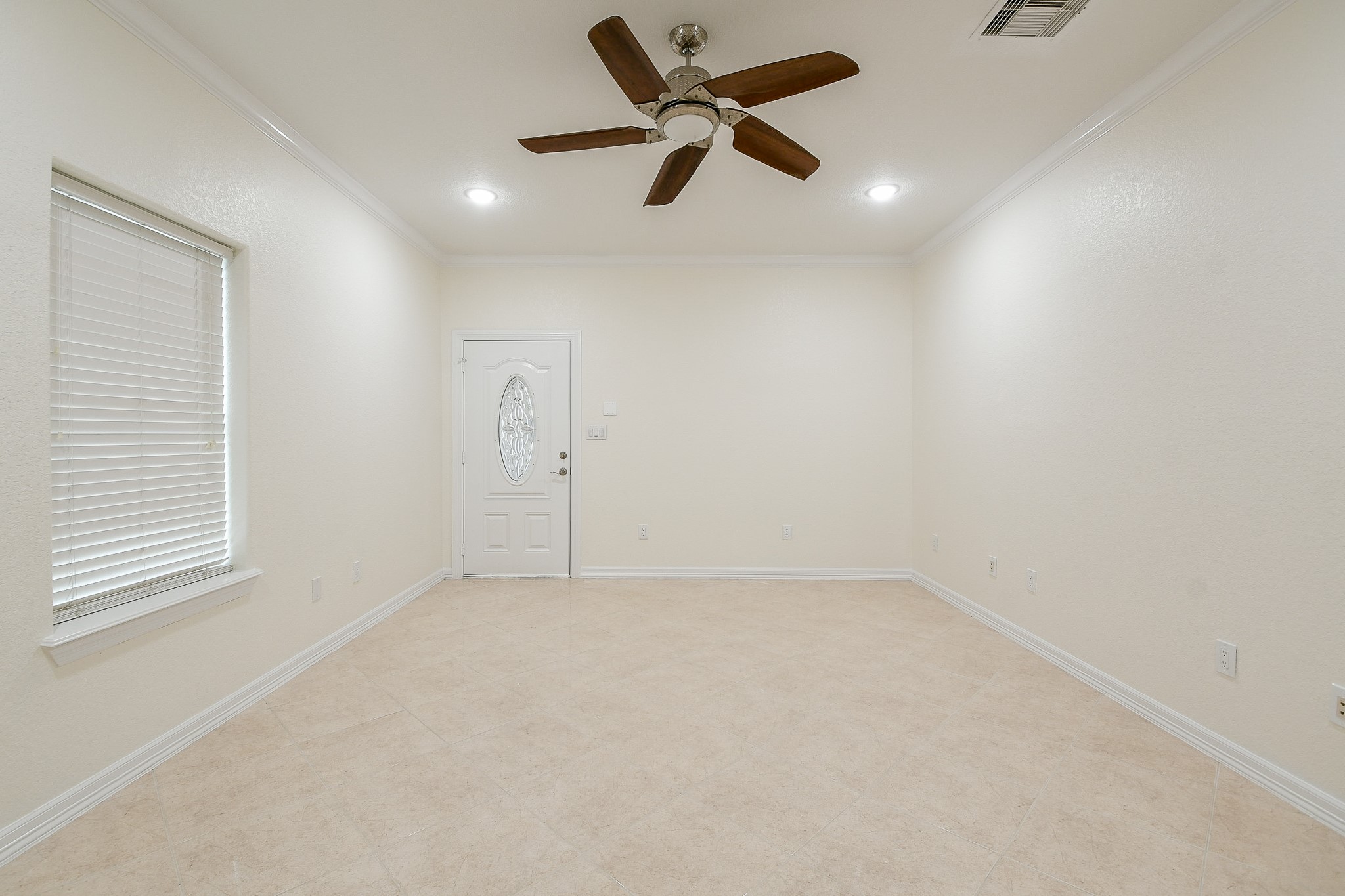 404 Moss Street Houston, TX 77009 - Photo 22 of 40 an empty room with a window and a ceiling fan