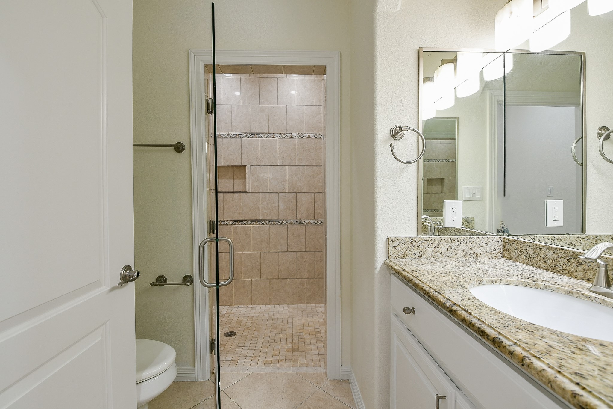 404 Moss Street Houston, TX 77009 - Photo 28 of 40 a bathroom with a granite countertop shower sink vanity and mirror