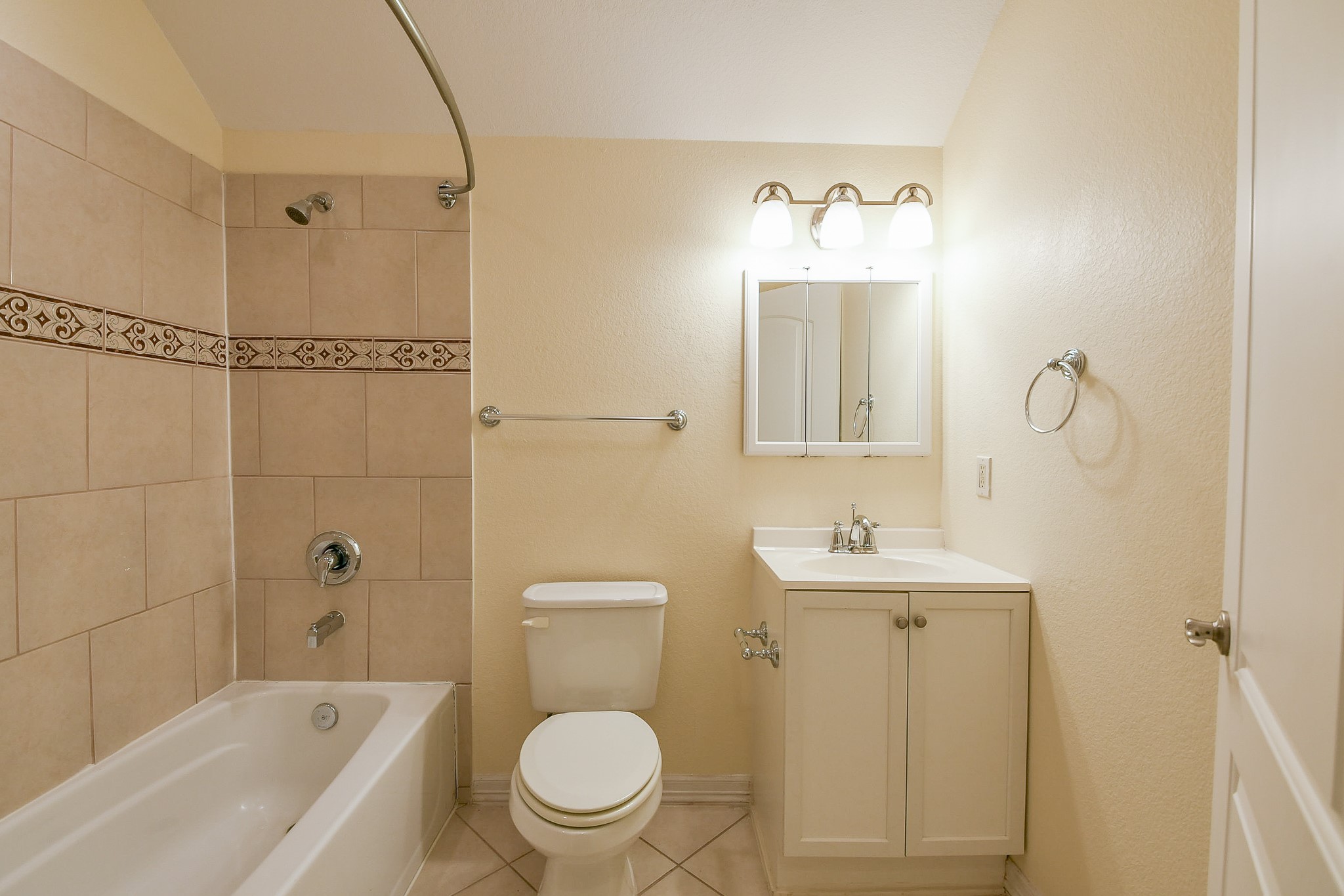 404 Moss Street Houston, TX 77009 - Photo 33 of 40 a bathroom with a toilet a sink a mirror a bathtub and vanity