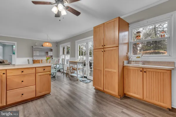 a living room with furniture and a dining table with kitchen view