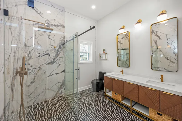 a spacious bathroom with a sink mirror and a shower