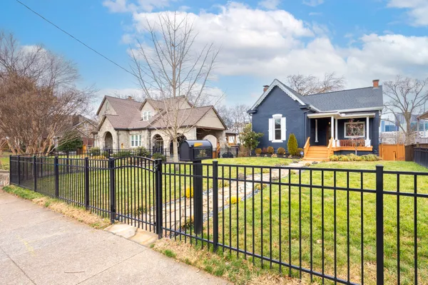 a front view of a house with a iron fence