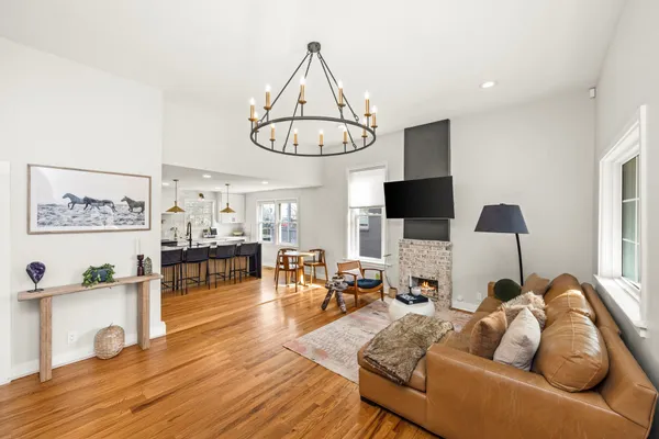 a living room with furniture fireplace and flat screen tv