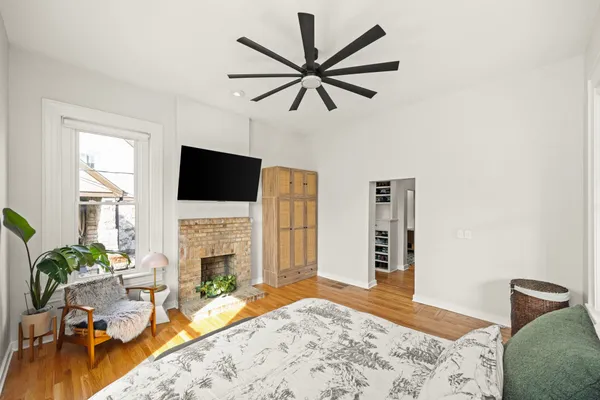 a bedroom with furniture fireplace and window