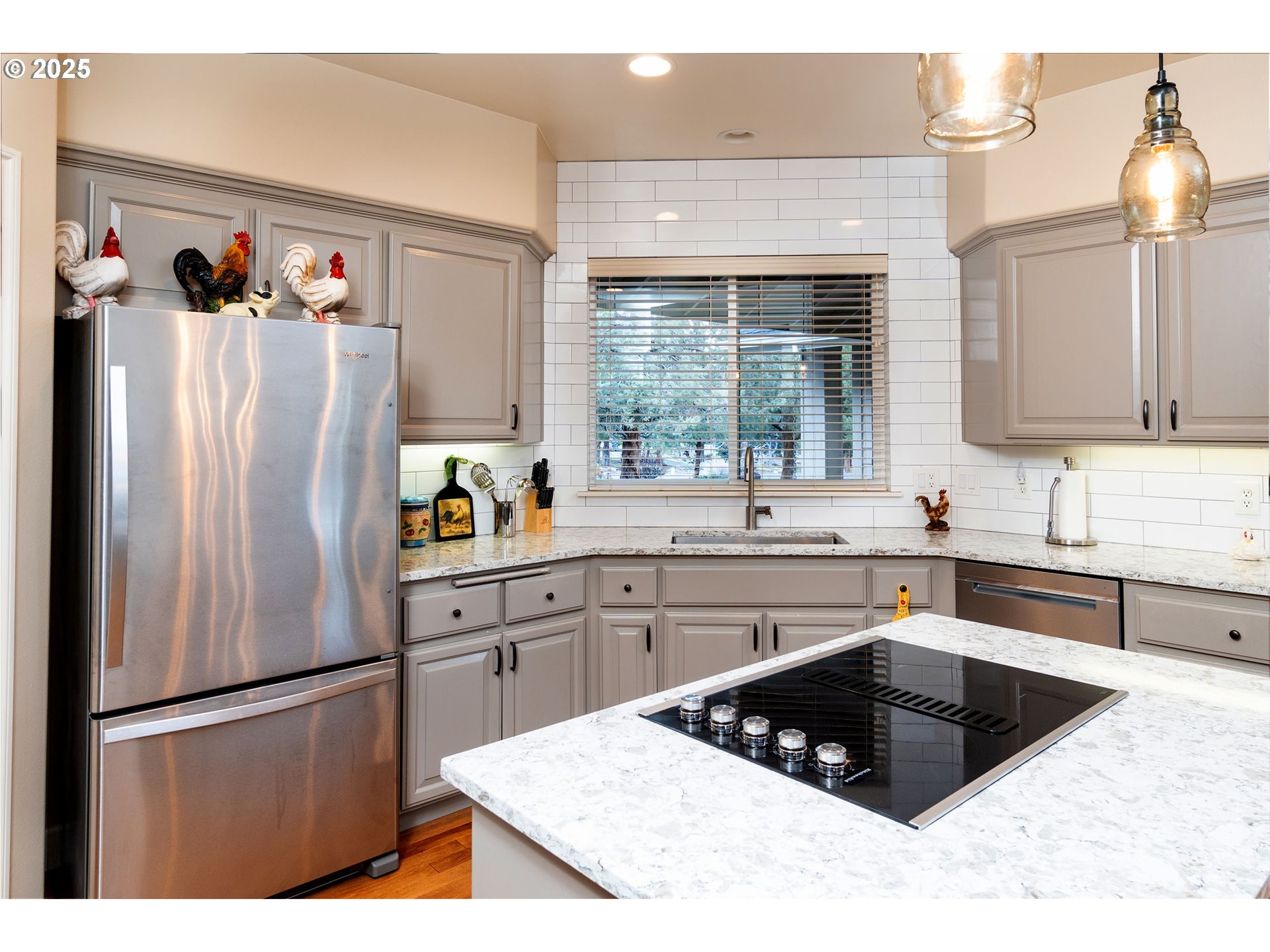8830 Merlin Drive Redmond, OR 97756 - Photo 11 of 32 a kitchen with a refrigerator a sink cabinets and a window