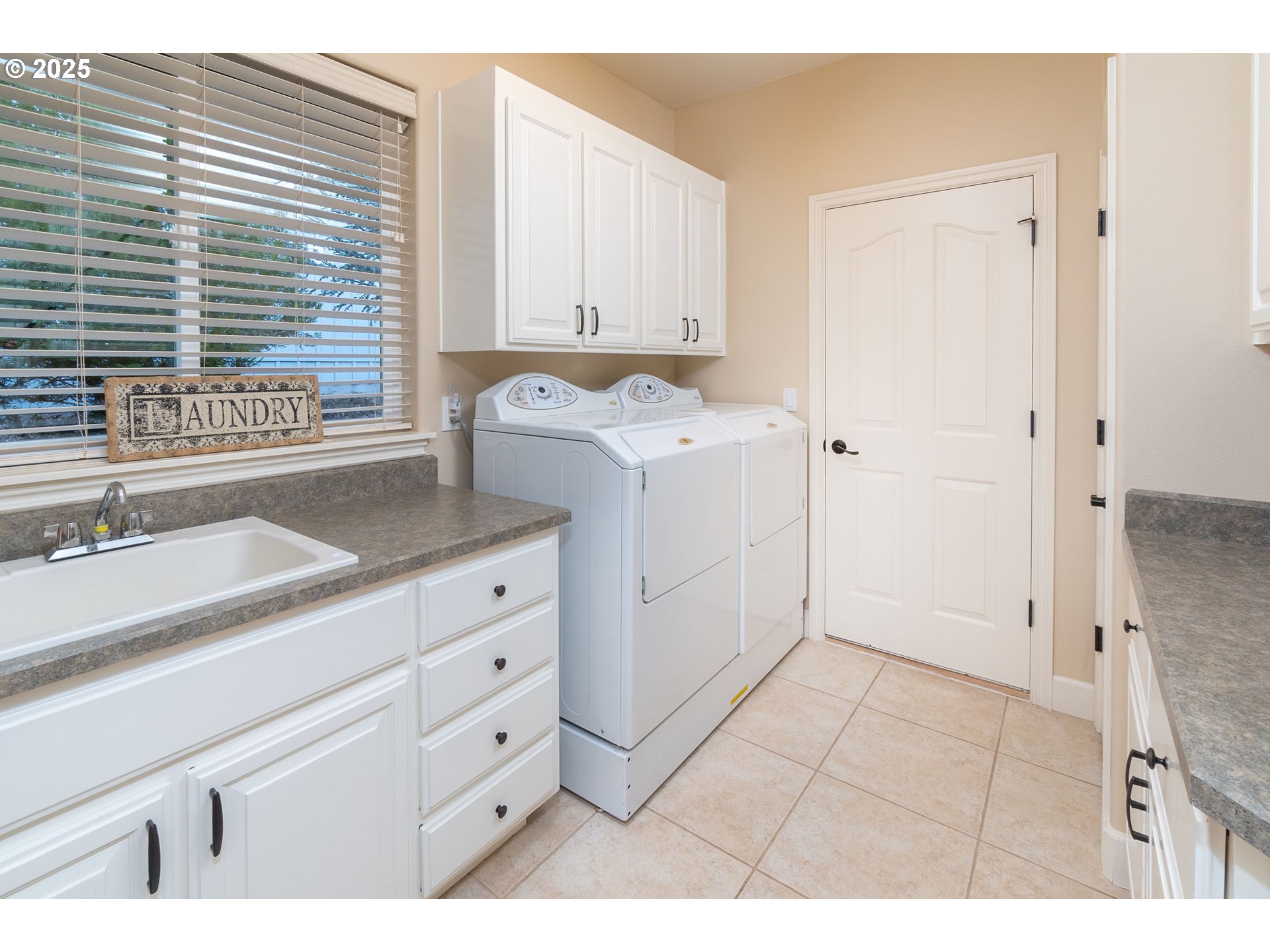 8830 Merlin Drive Redmond, OR 97756 - Photo 16 of 32 a utility room with cabinets washer and dryer