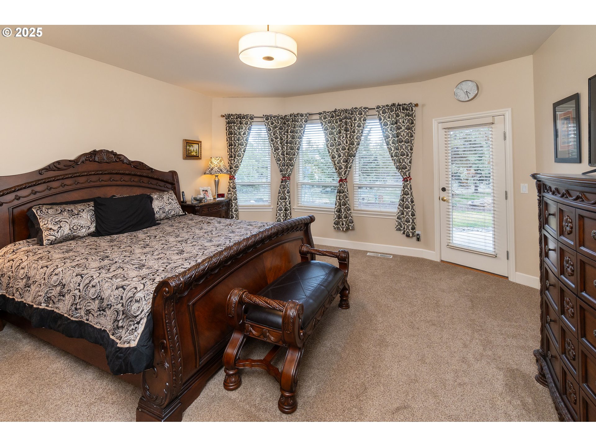 8830 Merlin Drive Redmond, OR 97756 - Photo 17 of 32 a bedroom with a bed and a large window