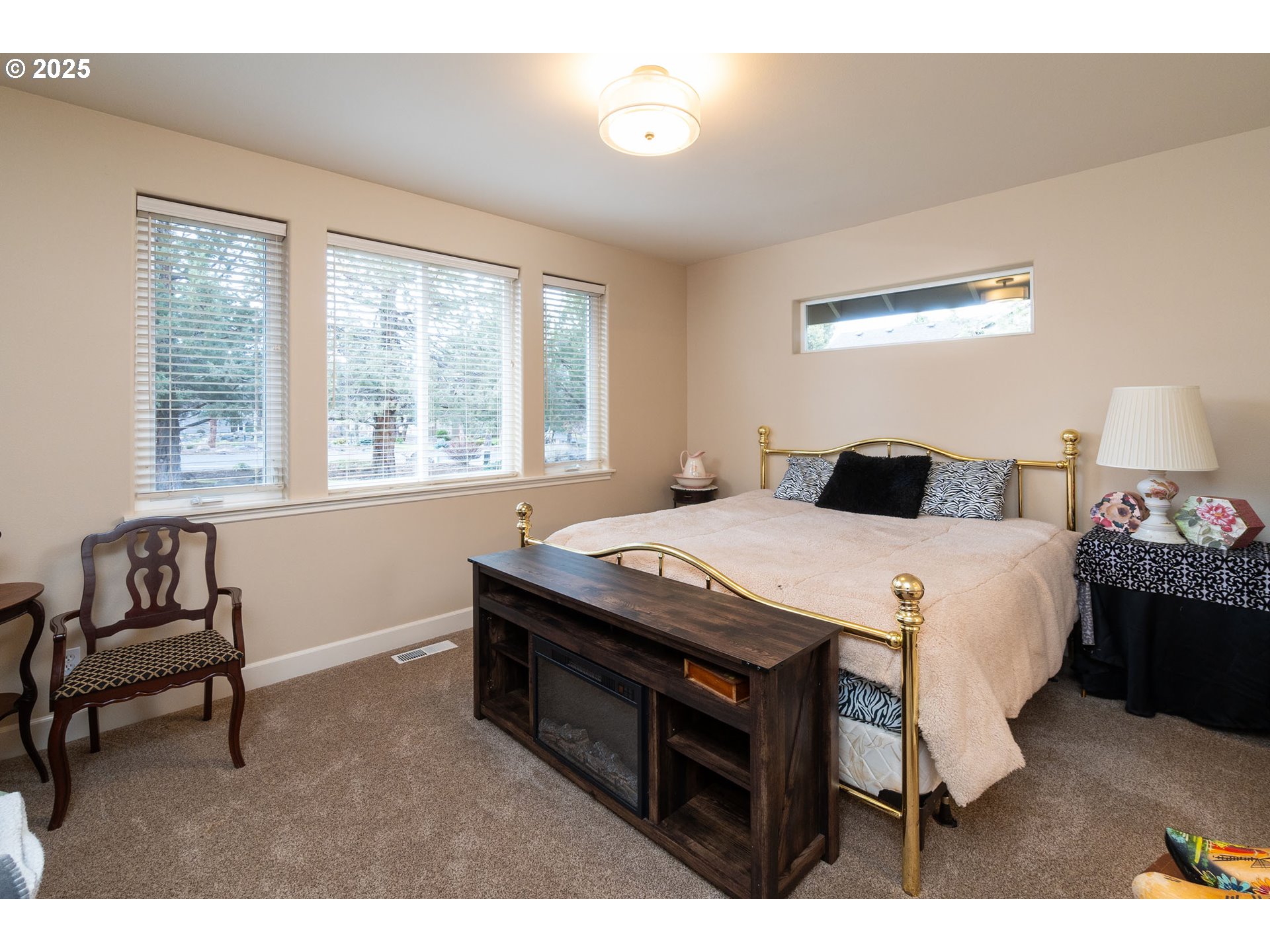 8830 Merlin Drive Redmond, OR 97756 - Photo 22 of 32 a bedroom with a bed and a couch