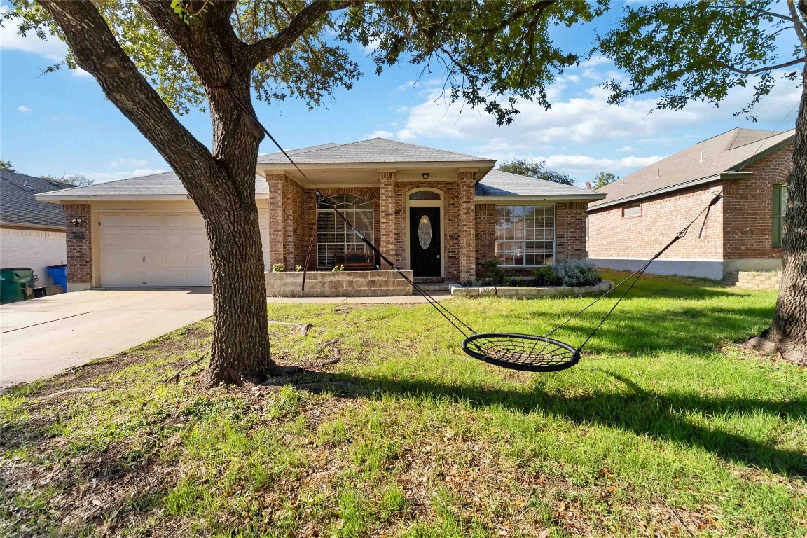 1320 Lochaline Loop Pflugerville, TX 78660 - Photo 1 of 35 Single story home featuring a front lawn, brick siding, driveway, and a garage