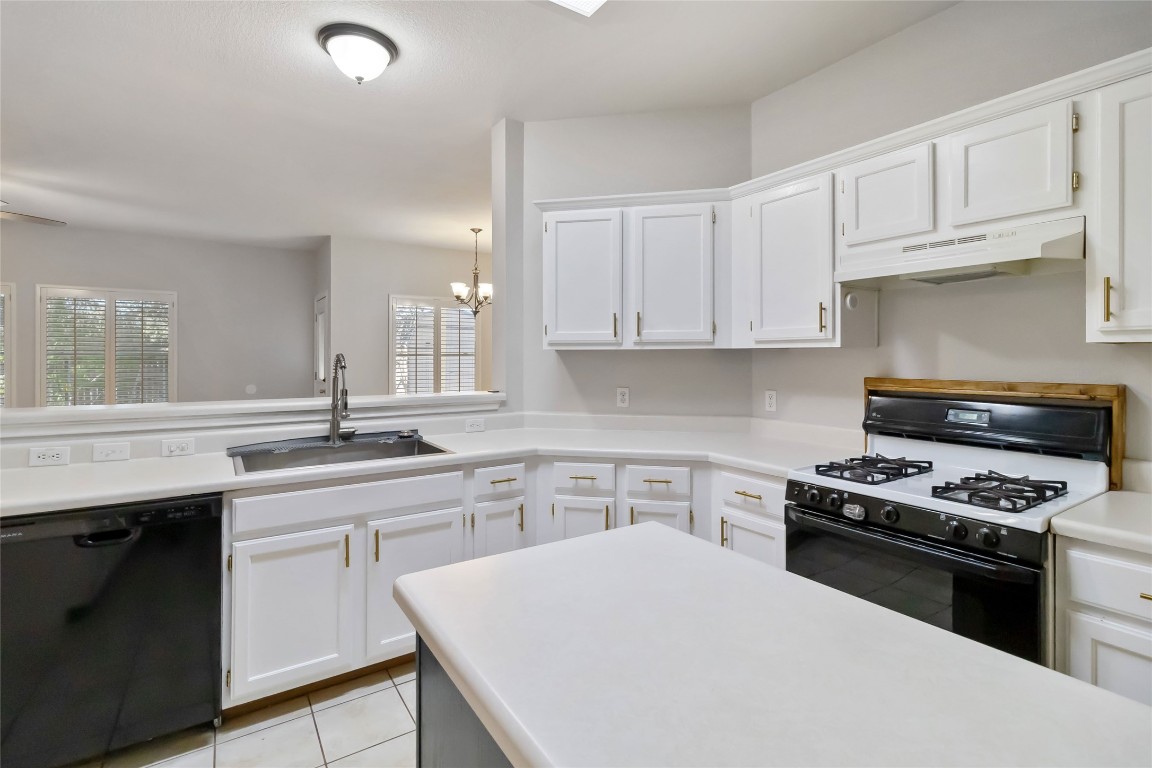 1320 Lochaline Loop Pflugerville, TX 78660 - Photo 12 of 35 Kitchen featuring white cabinetry and light countertops