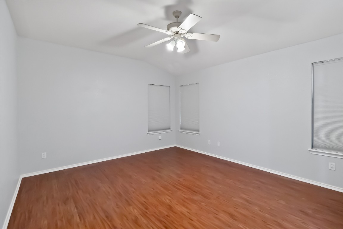 1320 Lochaline Loop Pflugerville, TX 78660 - Photo 16 of 35 Spare room featuring wood finished floors, lofted ceiling, and a ceiling fan