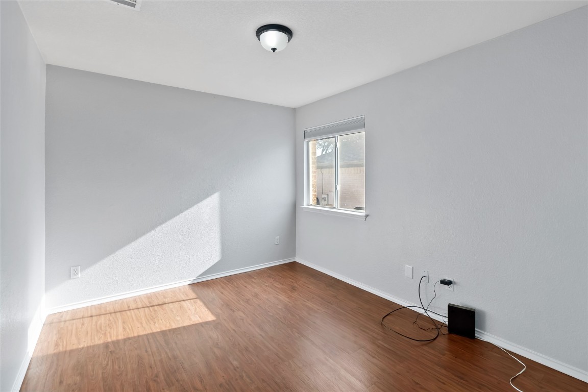1320 Lochaline Loop Pflugerville, TX 78660 - Photo 26 of 35 Unfurnished room featuring wood finished floors and baseboards