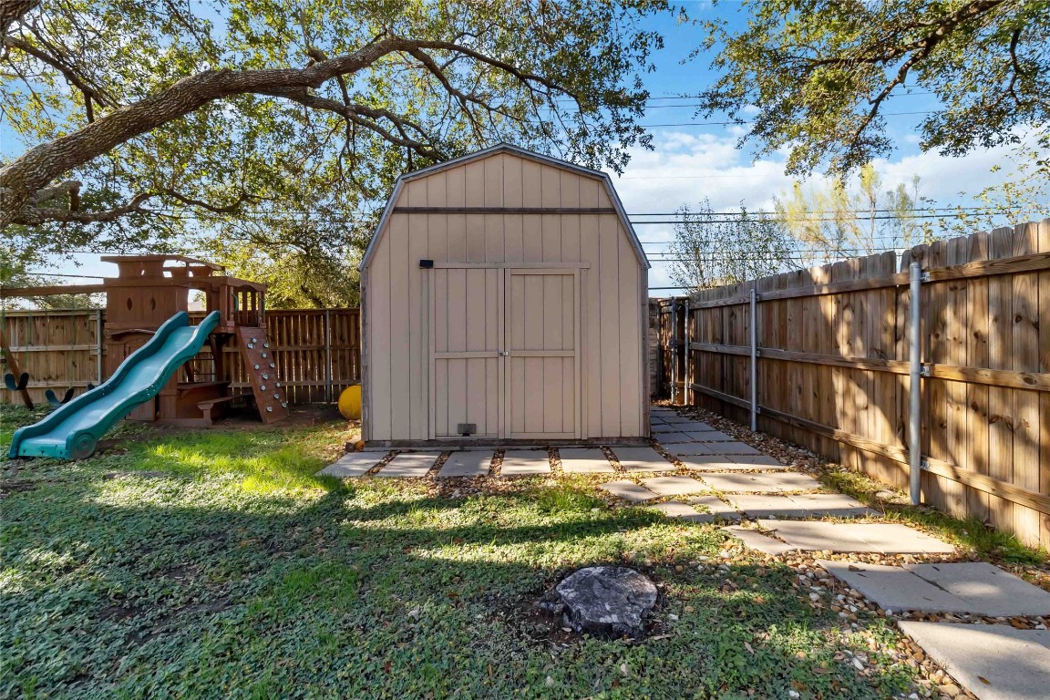 1320 Lochaline Loop Pflugerville, TX 78660 - Photo 31 of 35 View of shed featuring a playground and a fenced backyard