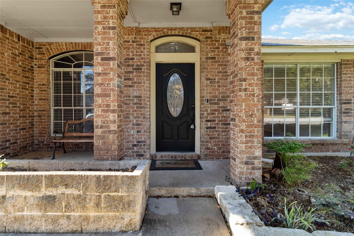 1320 Lochaline Loop Pflugerville, TX 78660 - Photo 4 of 35 Doorway to property featuring covered porch and brick siding
