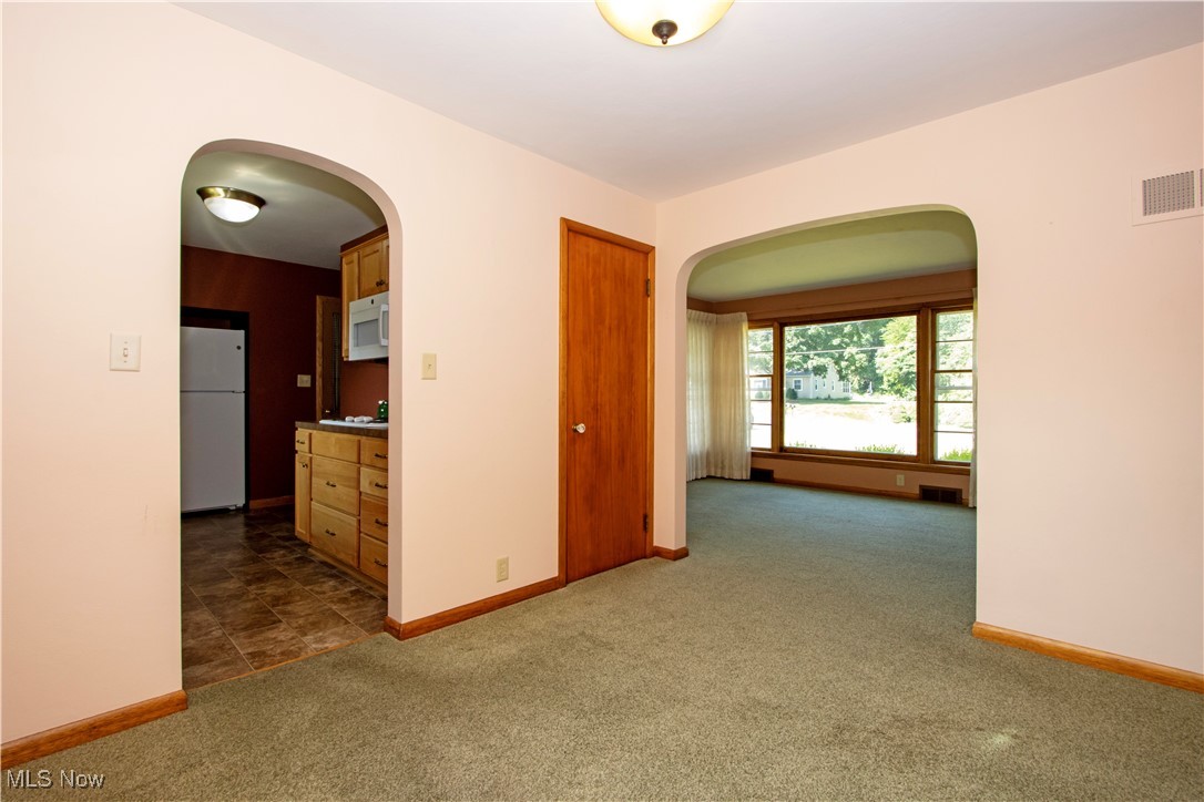 2456 Batdorf Road Wooster, OH 44691 - Photo 6 of 22 Empty room featuring arched walkways and dark carpet
