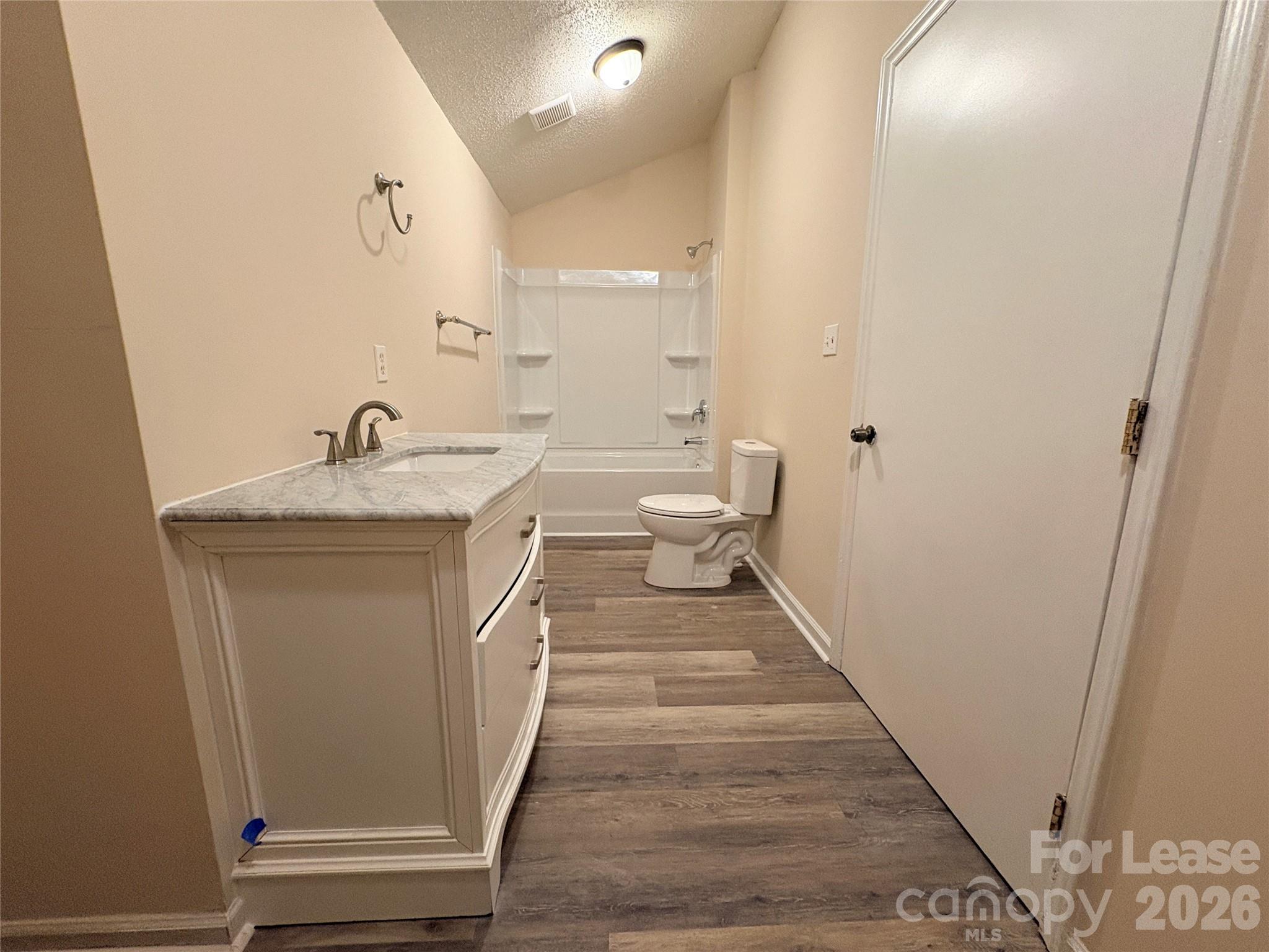 1109 6th Street, Unit B Lancaster, SC 29720 - Photo 21 of 22 a en suite bathroom with a granite countertop sink