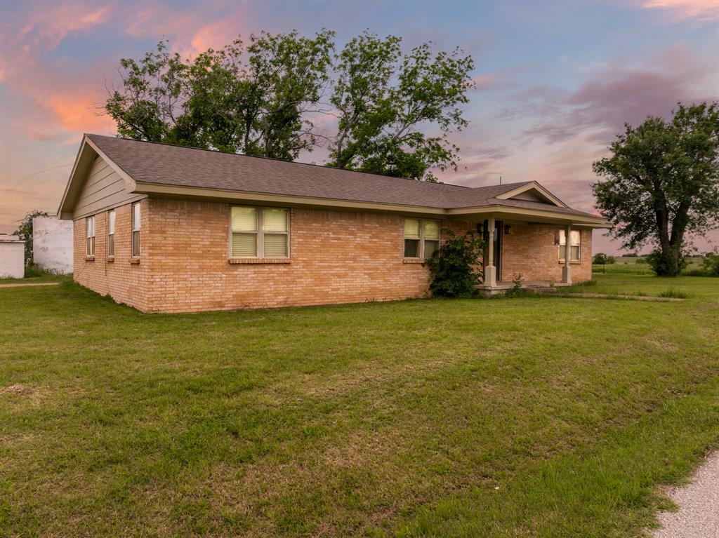 12069 Fm-1602 Hamilton, TX 76531 - Photo 3 of 32 View of front of property with brick siding, a front yard, and roof with shingles