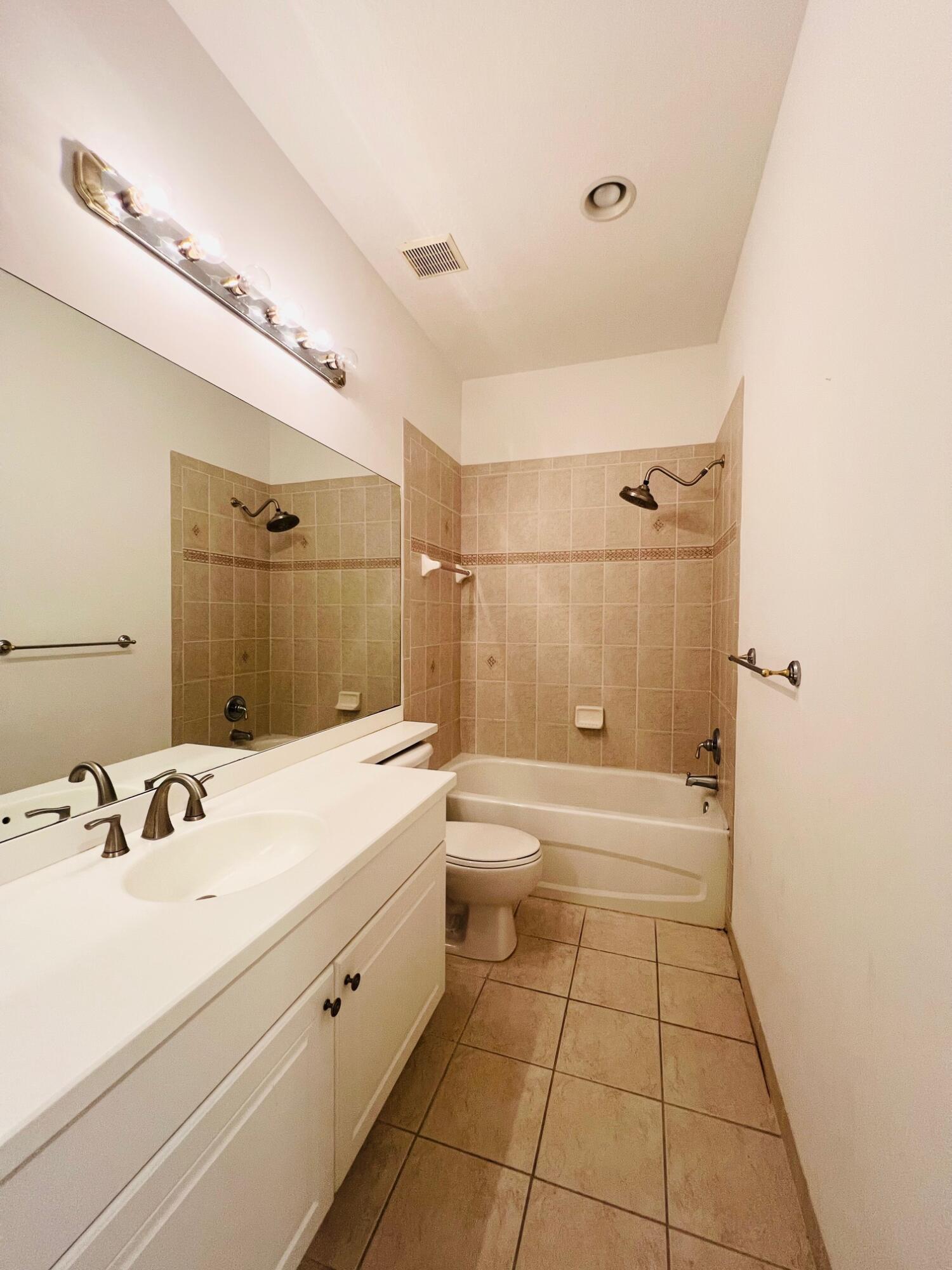 30 Beechdale Lane Boynton Beach, FL 33426 - Photo 22 of 25 a bathroom with a sink a toilet and shower