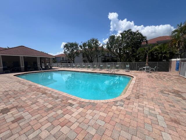 30 Beechdale Lane Boynton Beach, FL 33426 - Photo 24 of 25 a view of a swimming pool with an outdoor space and seating area