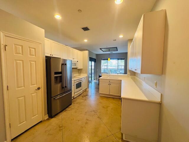 30 Beechdale Lane Boynton Beach, FL 33426 - Photo 4 of 25 a kitchen with refrigerator and countertop