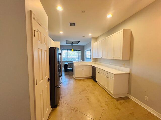 30 Beechdale Lane Boynton Beach, FL 33426 - Photo 5 of 25 a large kitchen with a large window and stainless steel appliances