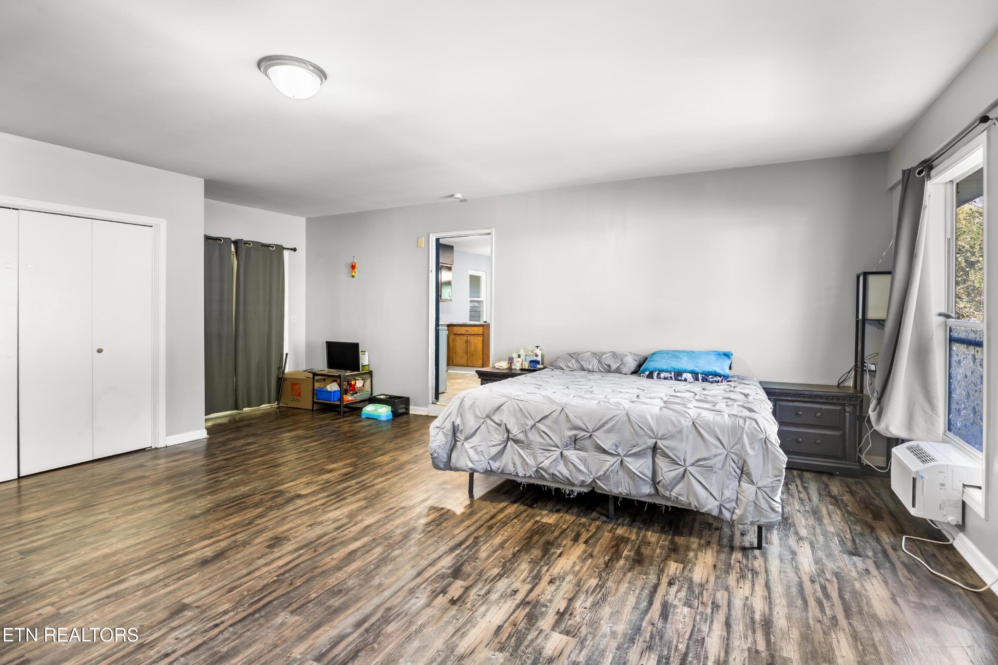 657 Robertsville Road Oak Ridge, TN 37830 - Photo 17 of 28 a bedroom with bed and a large mirror next to a window