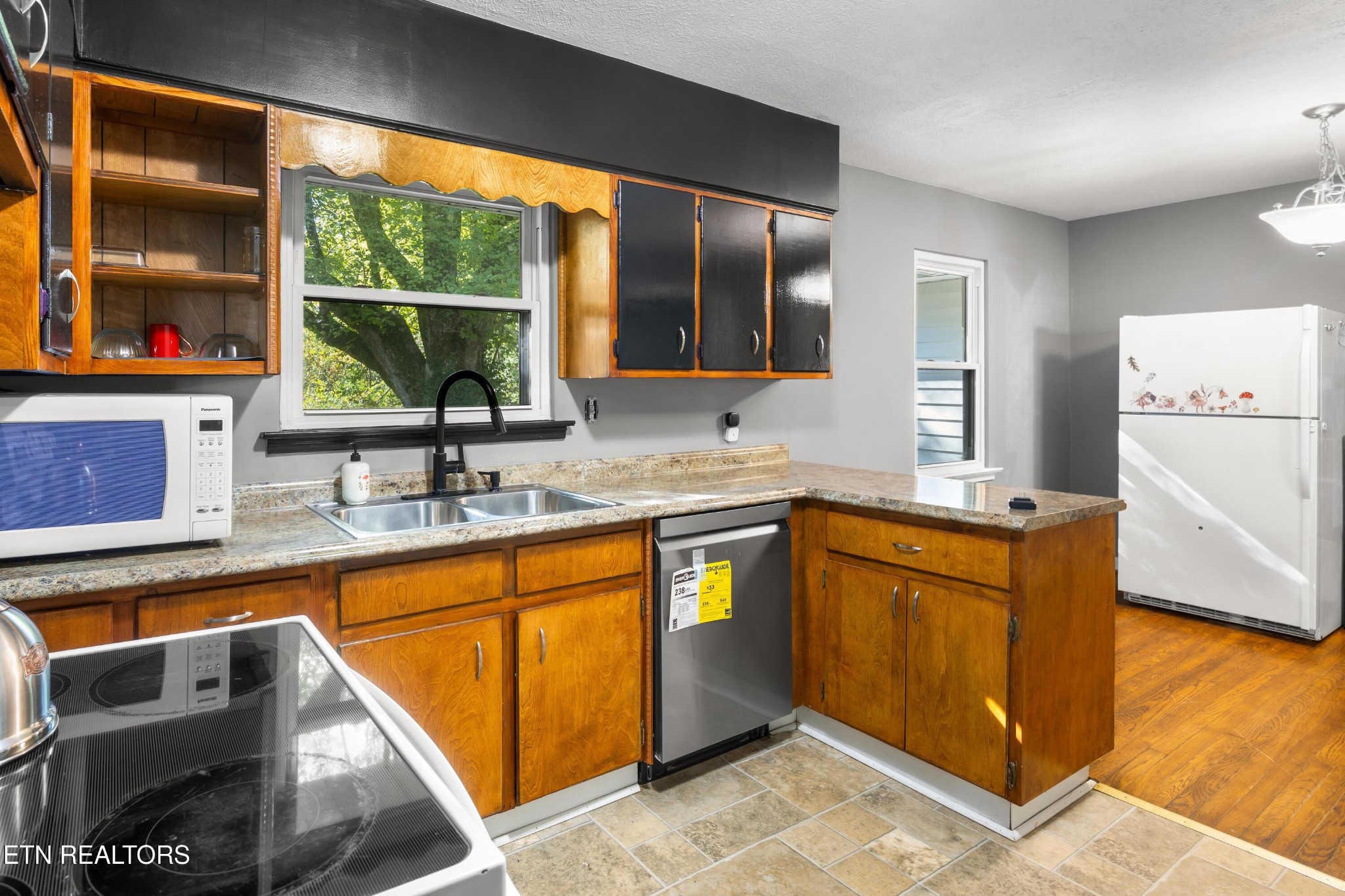 657 Robertsville Road Oak Ridge, TN 37830 - Photo 8 of 28 a kitchen with stainless steel appliances granite countertop a sink and a refrigerator