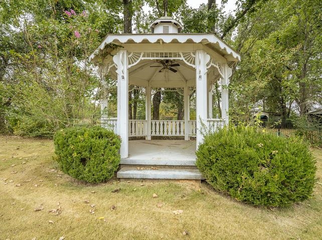 660 Hinton Road Counce, TN 38326 - Photo 27 of 40 White wooden gazebo with a built-in ceiling fan, balustrade railing, and concrete steps