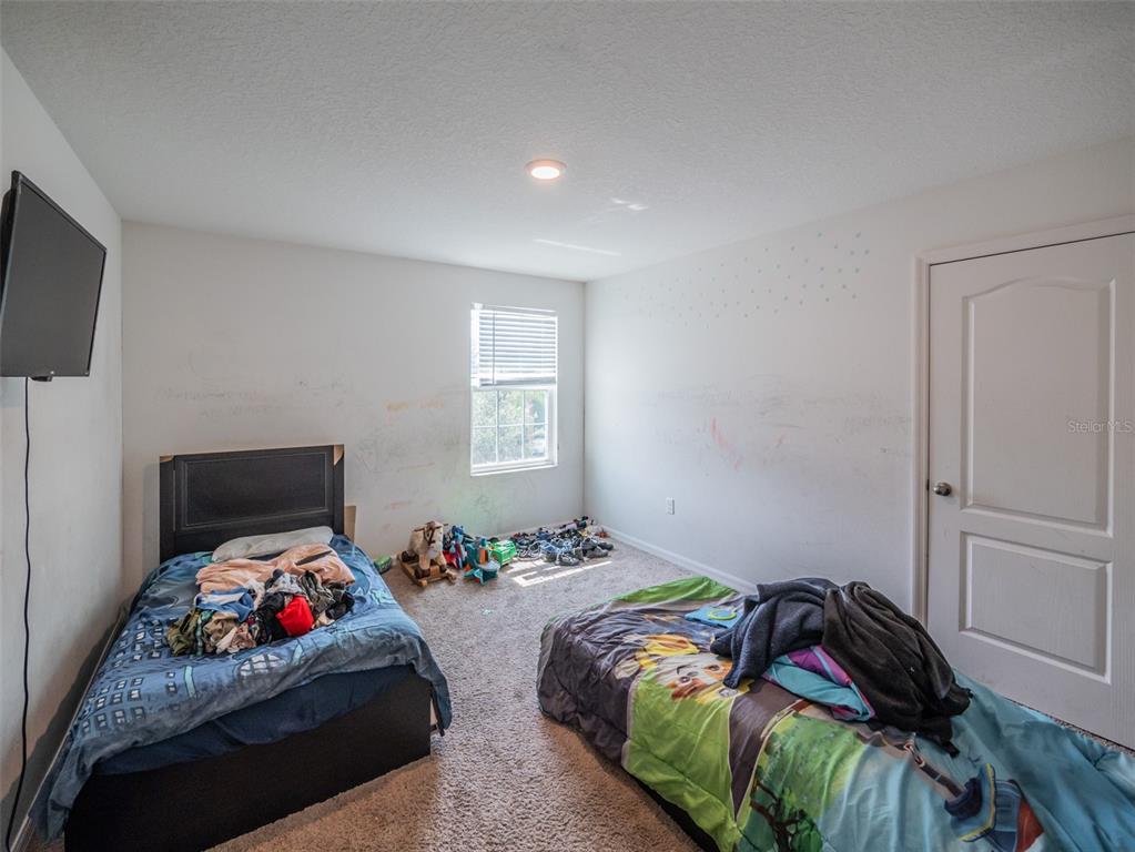 938 Mansfield Road Tavares, FL 32778 - Photo 12 of 25 a bedroom with a bed and a bed