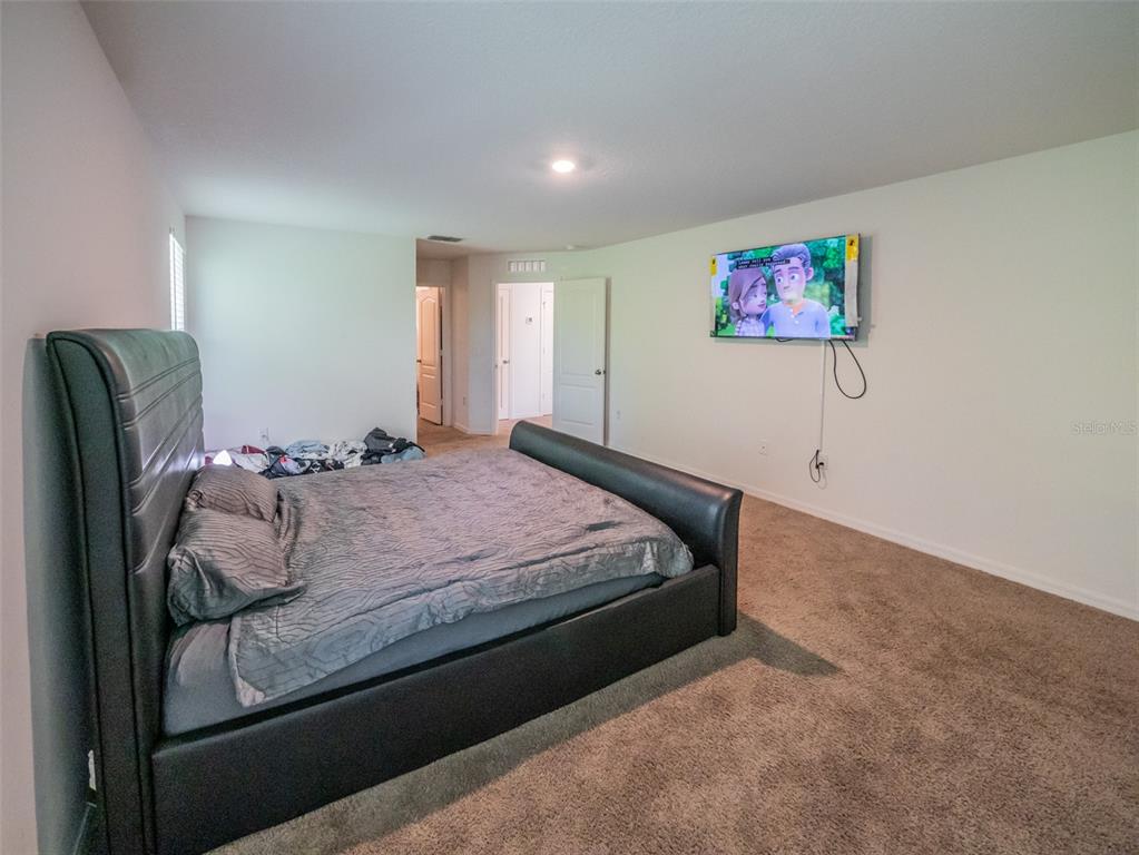 938 Mansfield Road Tavares, FL 32778 - Photo 15 of 25 a bedroom with bed and cupboard