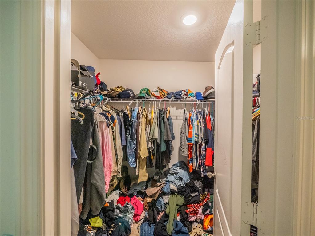 938 Mansfield Road Tavares, FL 32778 - Photo 17 of 25 a view of walk in closet with clothes