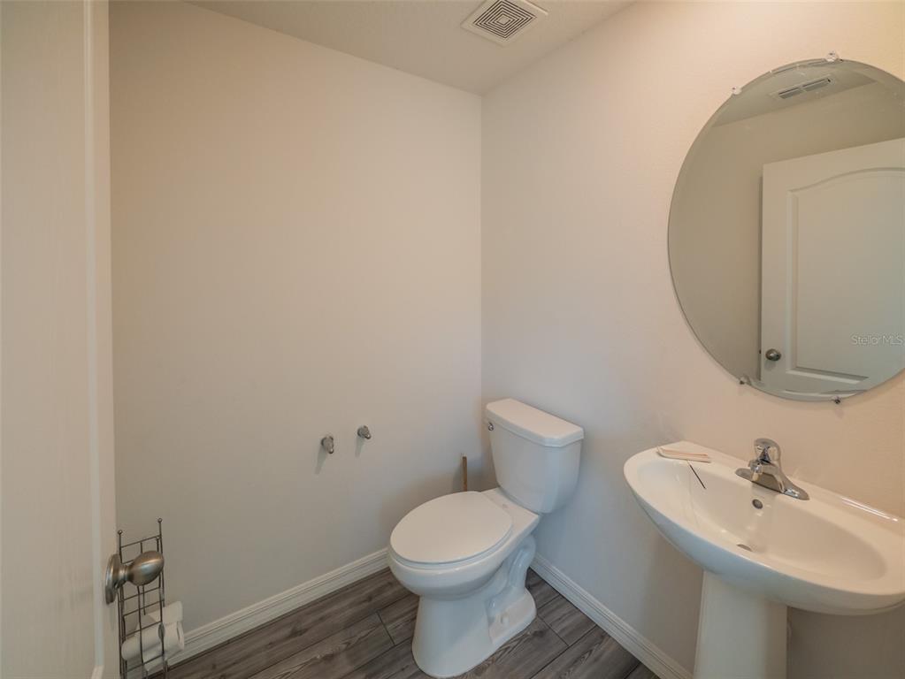 938 Mansfield Road Tavares, FL 32778 - Photo 19 of 25 a bathroom with a toilet sink and mirror