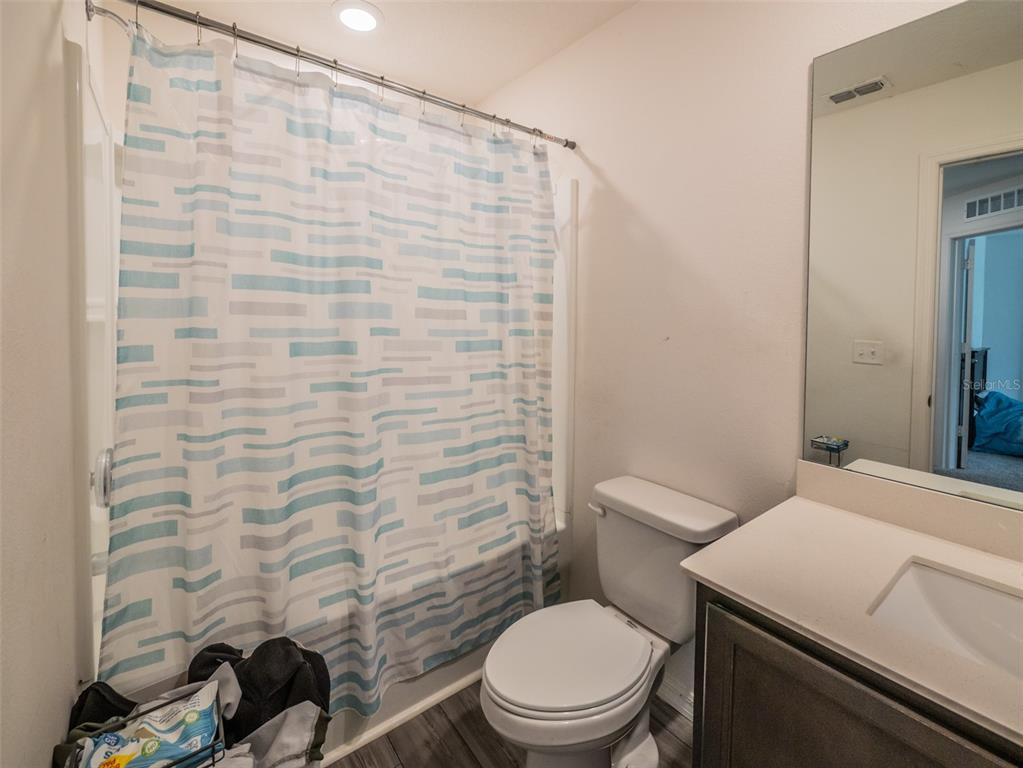 938 Mansfield Road Tavares, FL 32778 - Photo 20 of 25 a bathroom with a toilet and a shower curtain