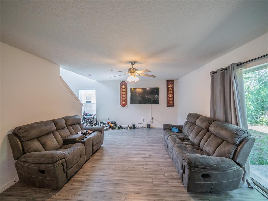 938 Mansfield Road Tavares, FL 32778 - Photo 6 of 25 a living room with furniture and a flat screen tv