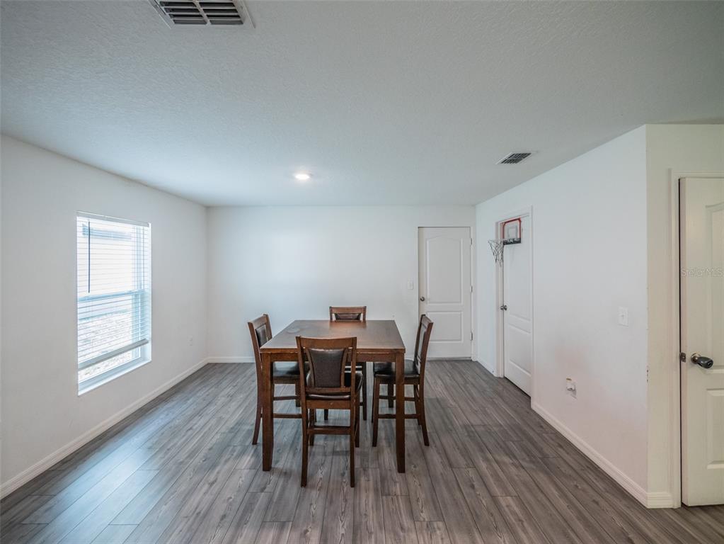 938 Mansfield Road Tavares, FL 32778 - Photo 9 of 25 a view of a dining room with furniture and wooden floor
