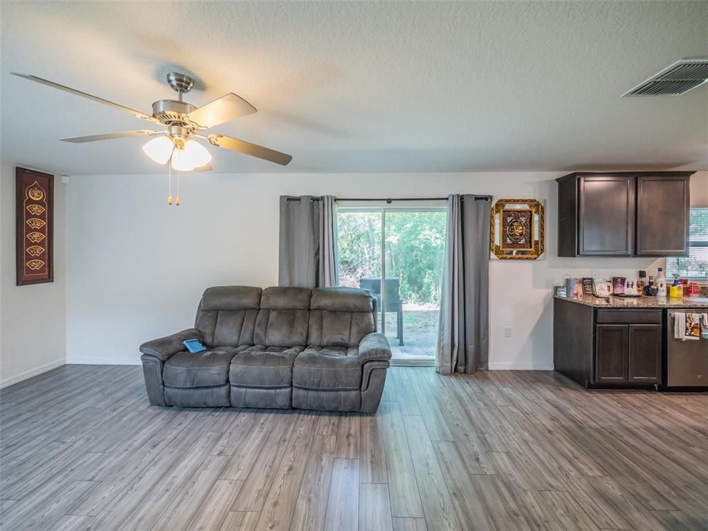 938 Mansfield Road Tavares, FL 32778 - Photo 10 of 25 a living room with furniture and a kitchen
