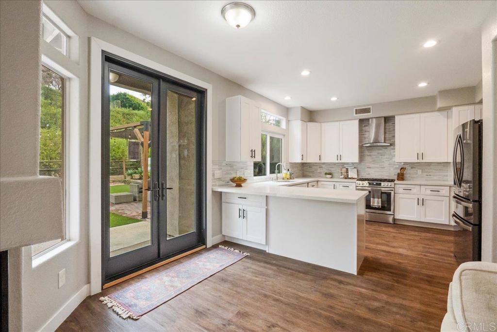 3631 Via Bernardo Oceanside, CA 92056 - Photo 11 of 38 a kitchen with white cabinets and white appliances