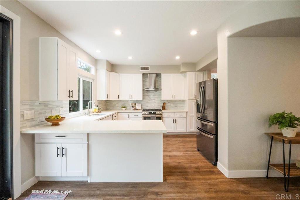 3631 Via Bernardo Oceanside, CA 92056 - Photo 12 of 38 a kitchen with refrigerator and white cabinets