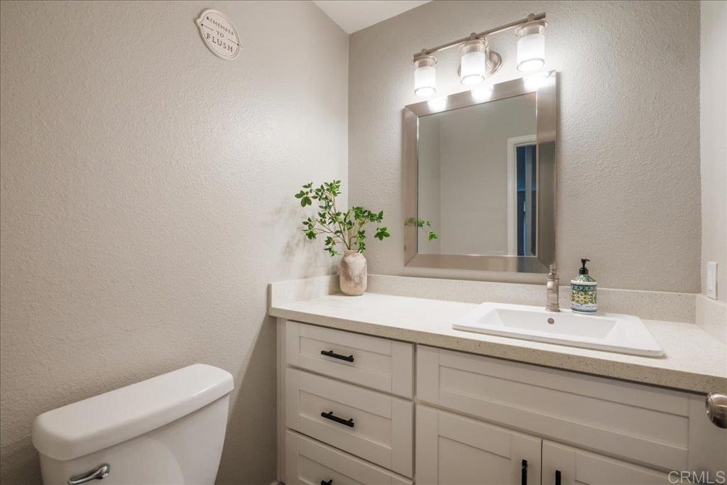 3631 Via Bernardo Oceanside, CA 92056 - Photo 16 of 38 a bathroom with a toilet sink and mirror
