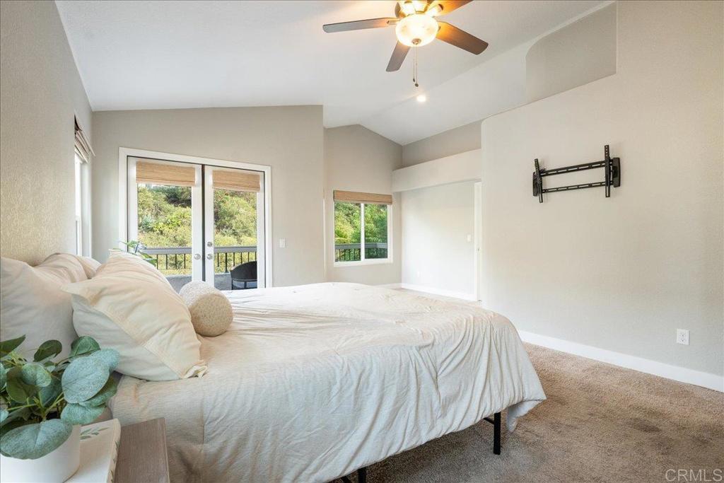 3631 Via Bernardo Oceanside, CA 92056 - Photo 18 of 38 a bedroom with a bed and a chandelier