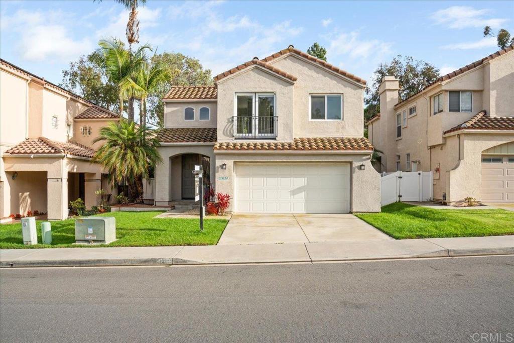 3631 Via Bernardo Oceanside, CA 92056 - Photo 2 of 38 a front view of a house with a garden and garage