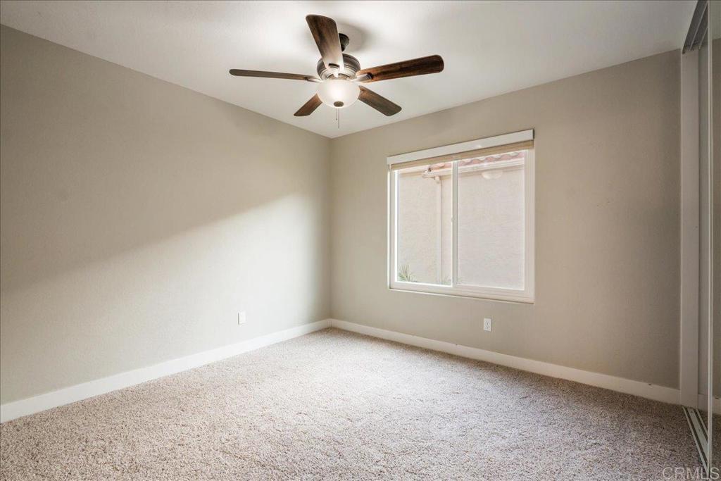 3631 Via Bernardo Oceanside, CA 92056 - Photo 24 of 38 an empty room with a window and a ceiling fan