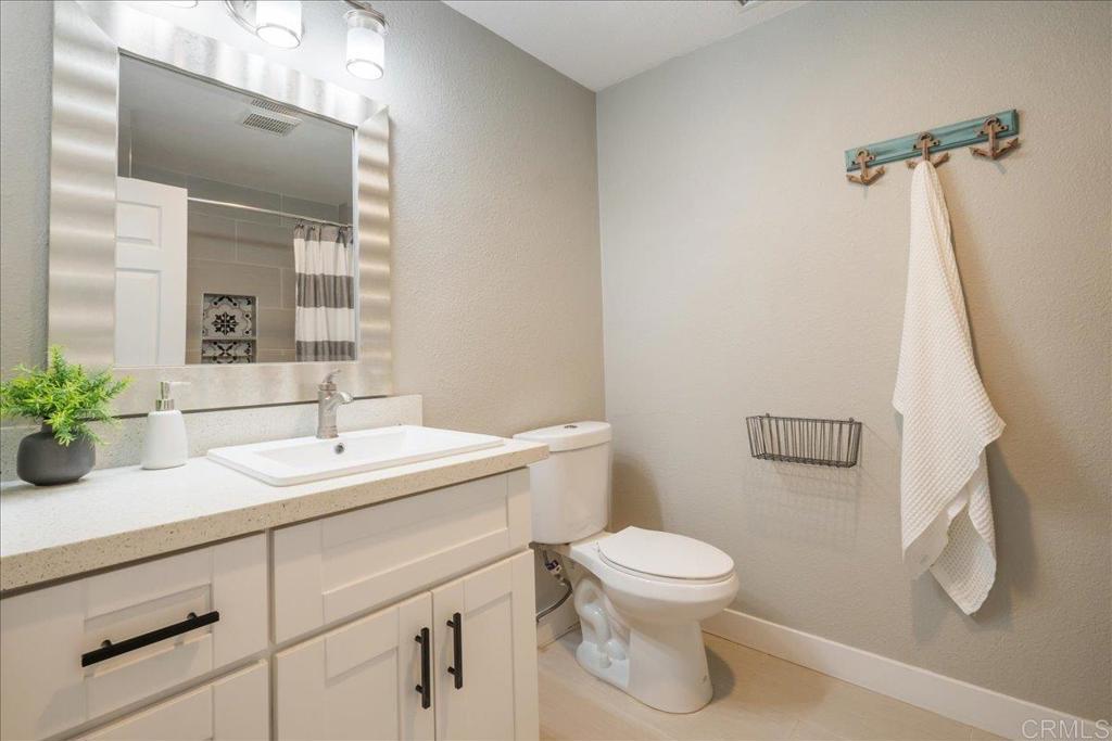 3631 Via Bernardo Oceanside, CA 92056 - Photo 25 of 38 a bathroom with a sink a toilet and a mirror