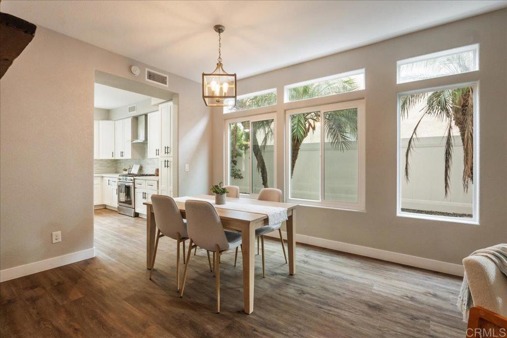 3631 Via Bernardo Oceanside, CA 92056 - Photo 7 of 38 a view of a dining room with furniture wooden floor and chandelier