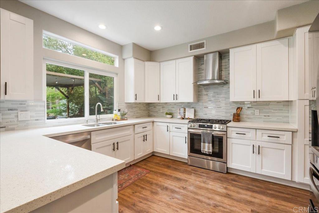 3631 Via Bernardo Oceanside, CA 92056 - Photo 10 of 38 a kitchen with granite countertop white cabinets and white appliances