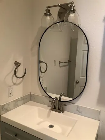 a bathroom with a sink and mirror
