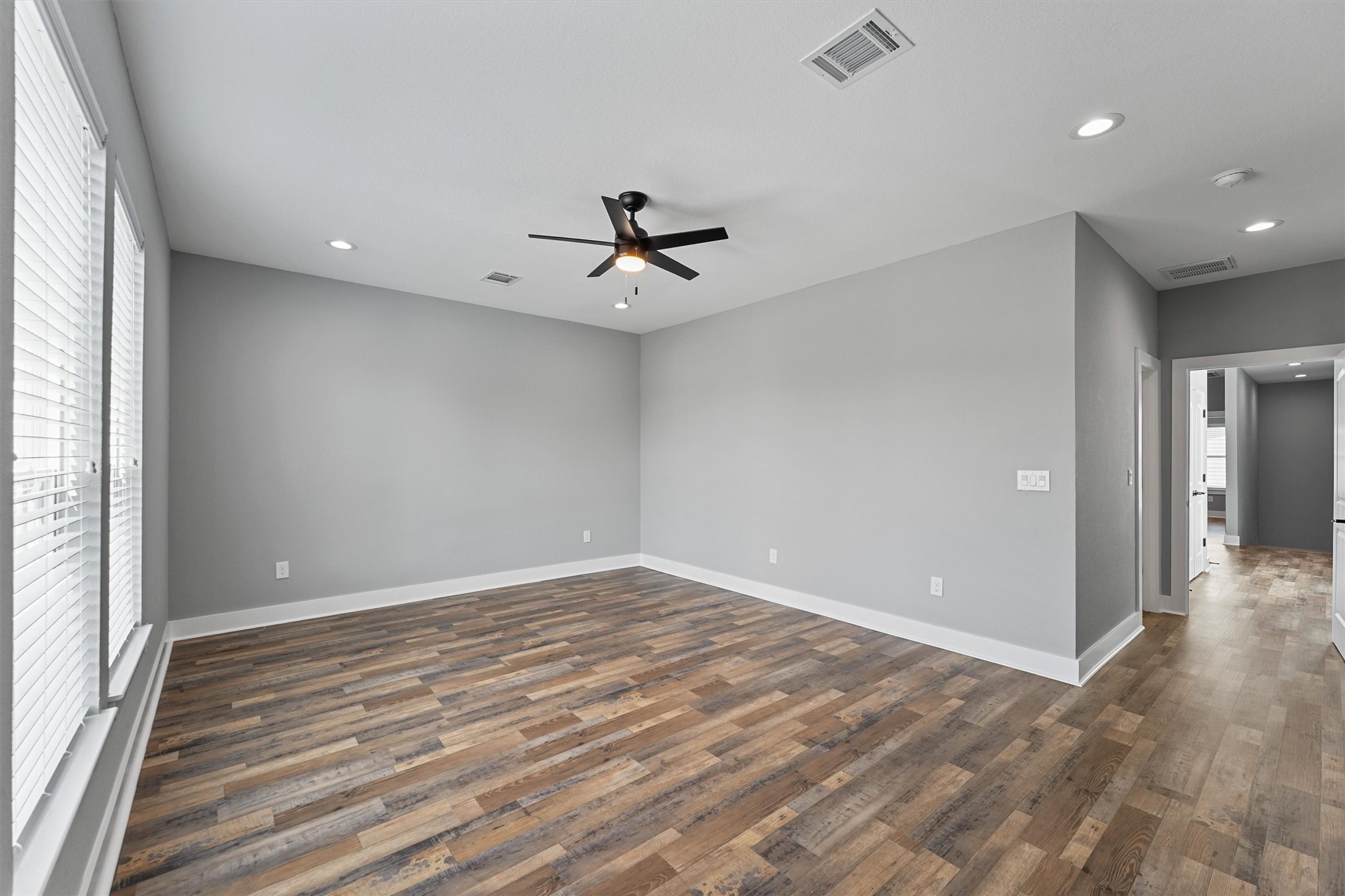 7704 Sealey Street Houston, TX 77088 - Photo 8 of 15 wooden floor in an empty room with a window